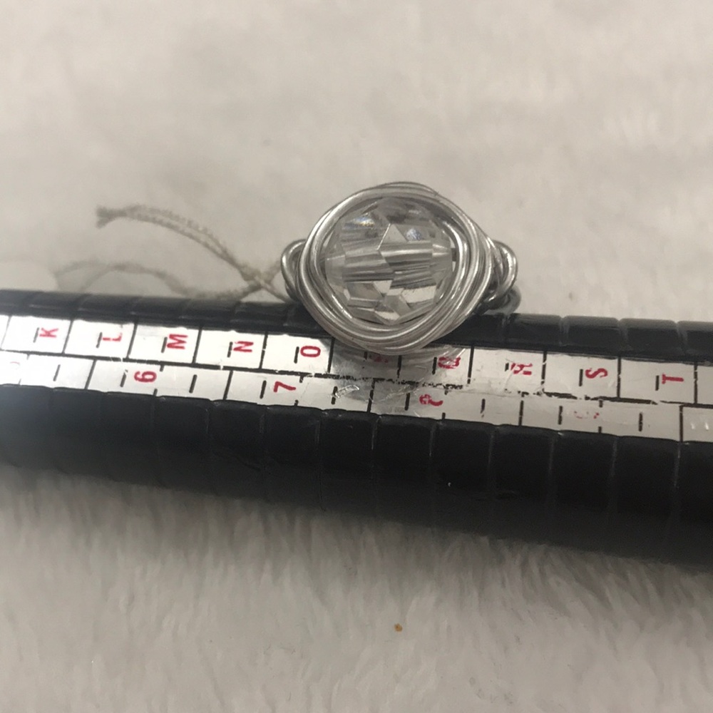 Silver wired ring with clear bead interiorly